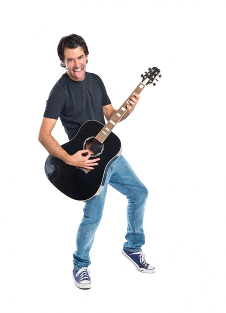 Handsome man with guitar over white background