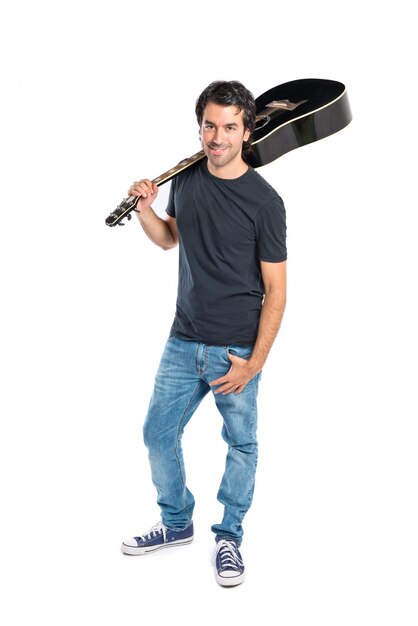 Handsome man with guitar over white background