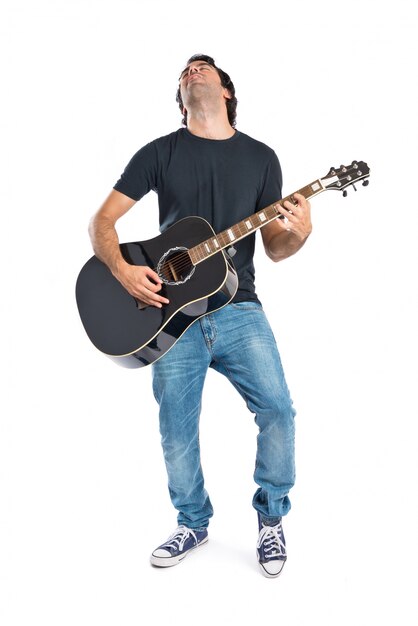 Handsome man with guitar over white background