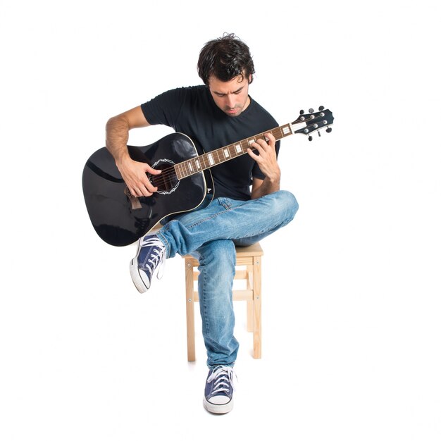 Handsome man with guitar over white background