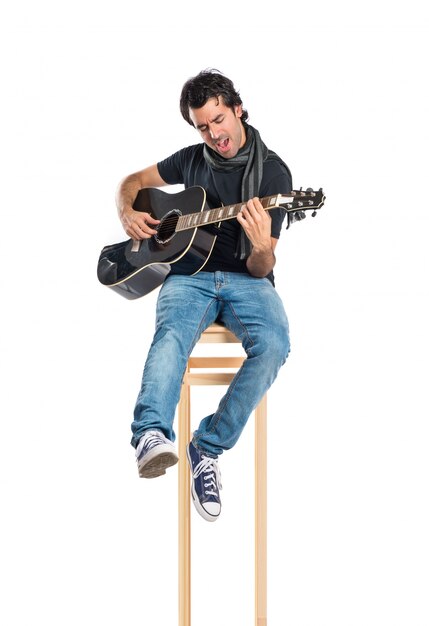 Handsome man with guitar over white background