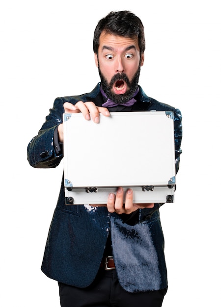 Handsome man with sequin jacket holding a briefcase