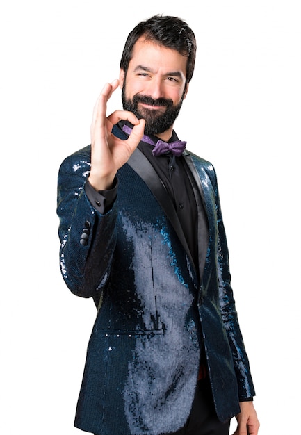 Handsome man with sequin jacket making OK sign