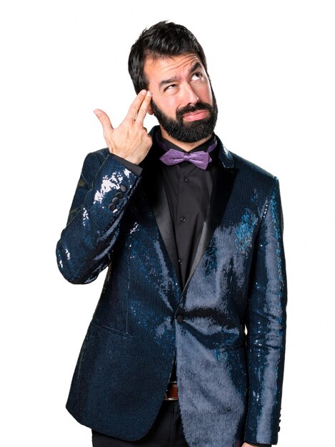 Handsome man with sequin jacket making suicide gesture