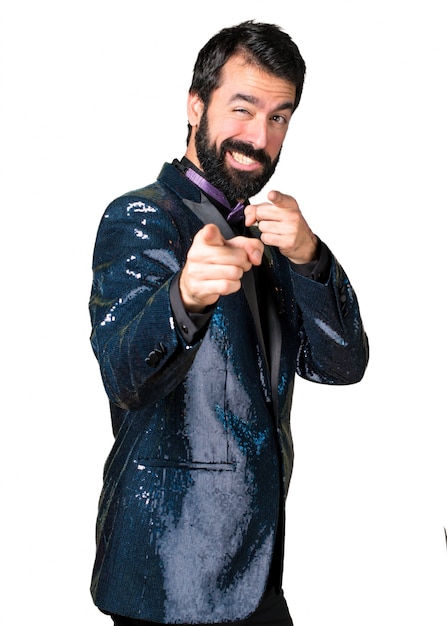 Handsome man with sequin jacket pointing to the front