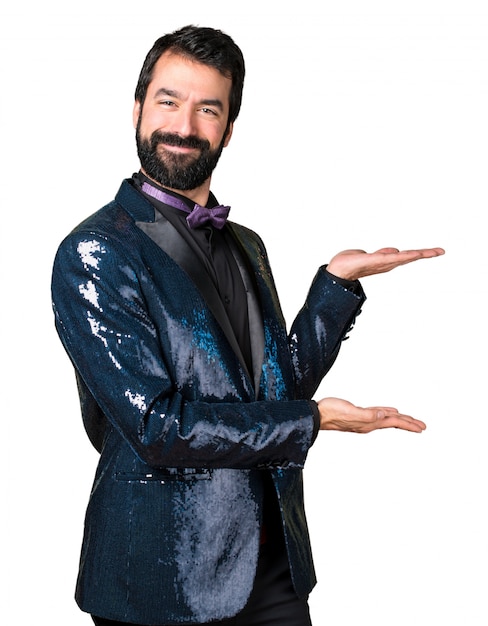 Handsome man with sequin jacket presenting something