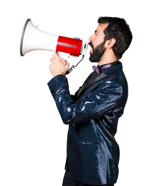 Handsome man with sequin jacket shouting by megaphone