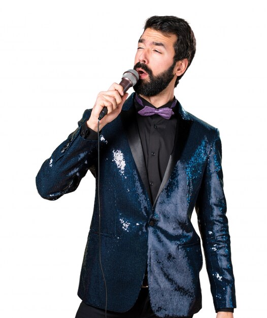 Handsome man with sequin jacket singing with microphone