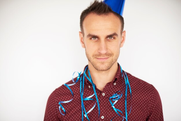 Handsome man with streamer and party hat