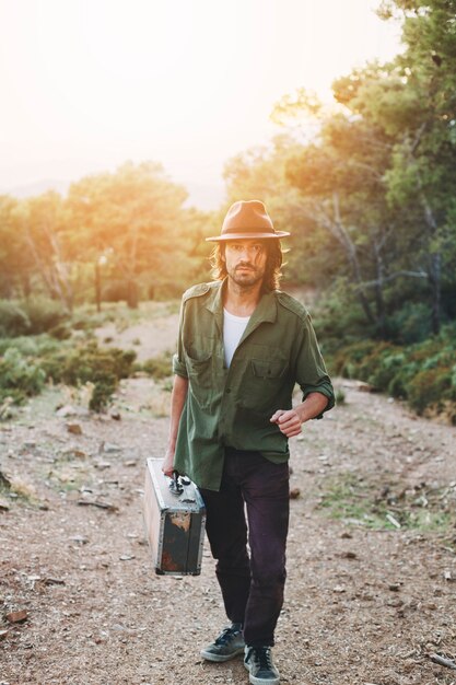 Free photo handsome man with suitcase]