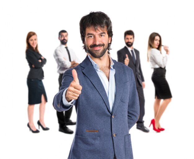 Handsome man with thumb up over white background  