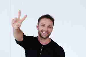 Free photo handsome man with v sign, for peace or victory