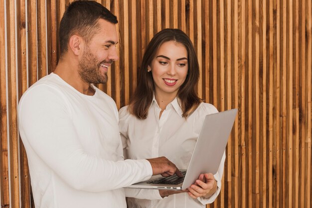 Handsome man and woman using a laptop