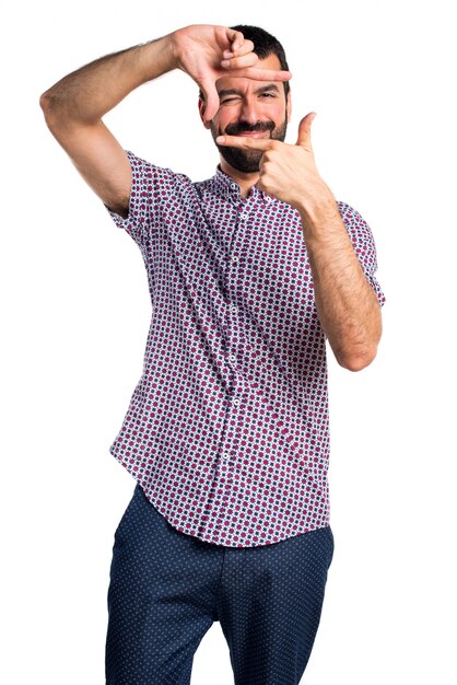 Handsome manfocusing with his fingers