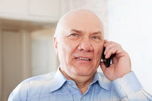 handsome mature man speaking by phone