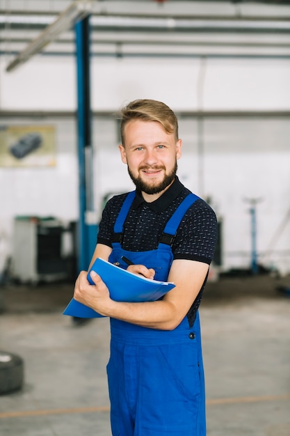 Handsome mechanic with pen and folder