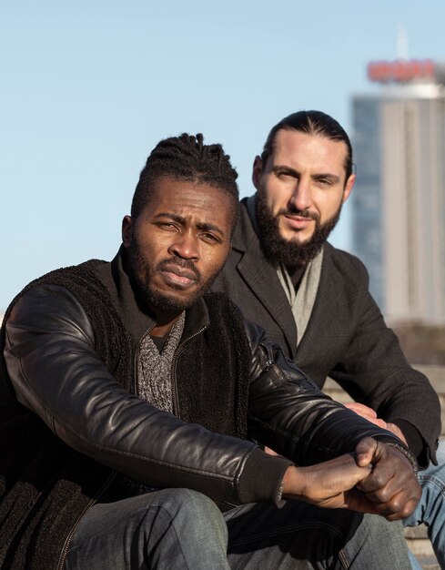 Handsome men posing outdoors in the sun