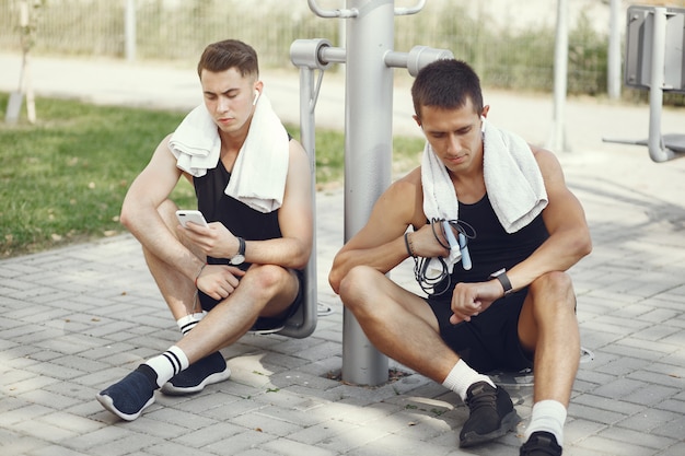 Handsome men in a sports clothes sitting near simulators