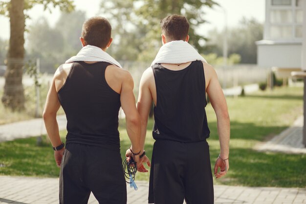 Handsome men in a sports clothes standing in a park