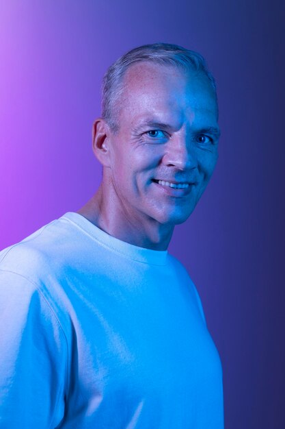 Handsome middle aged man portrait in neon lights