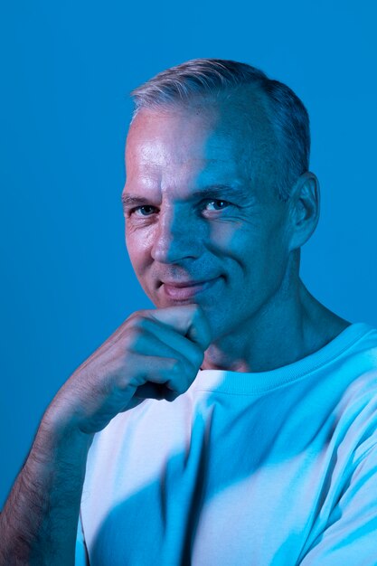 Handsome middle aged man portrait in neon lights