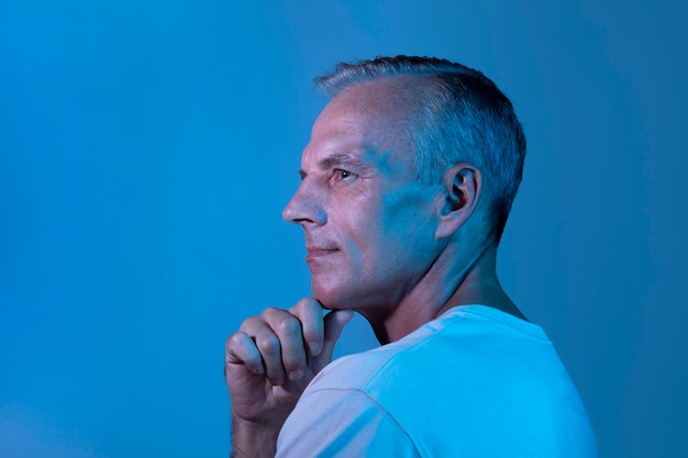 Handsome middle aged man portrait in neon lights