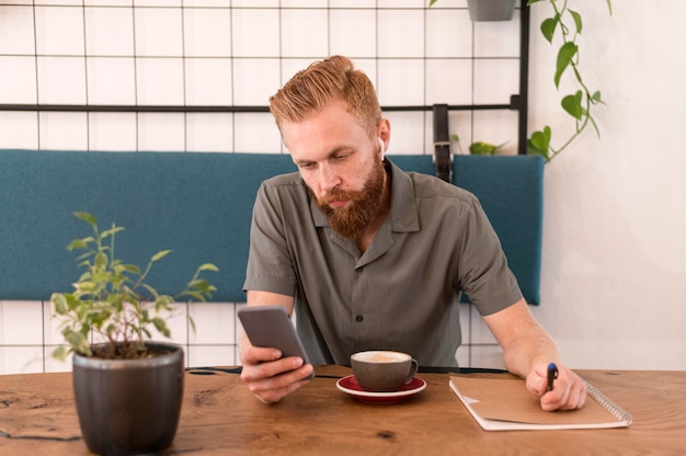 Handsome modern man looking at his phone