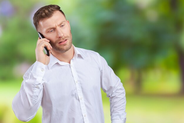 Handsome salesman talking on mobile phone