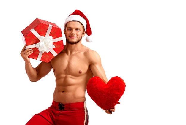 Handsome santa claus holding heart and a present