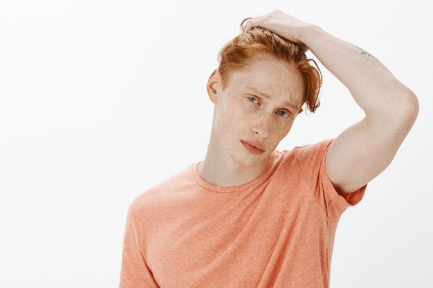 Handsome sassy redhead man looking cool at camera