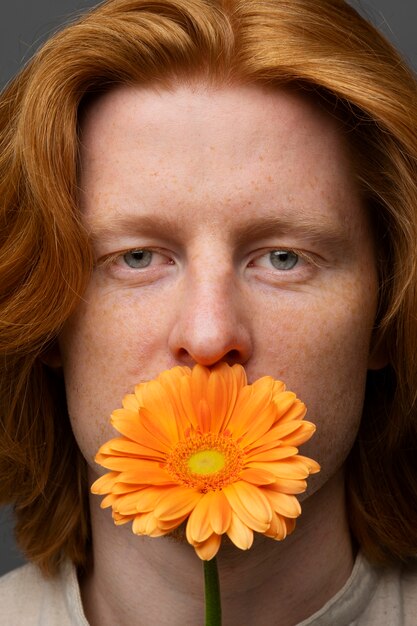 Handsome and sensitive man with flower