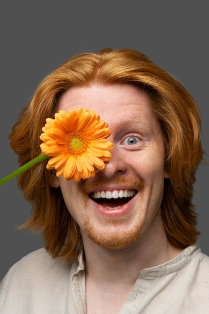 Free photo handsome and sensitive man with flower