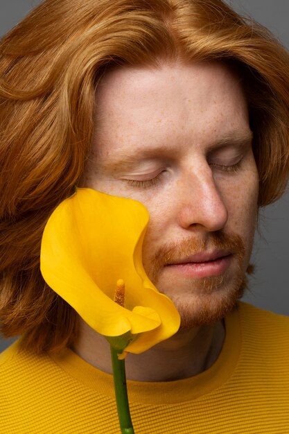 Handsome and sensitive man with flower