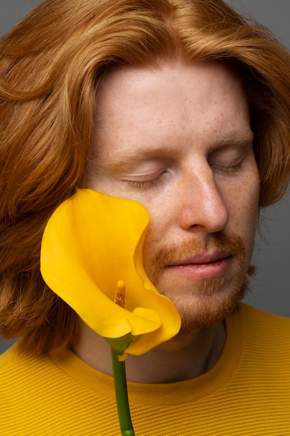 Handsome and sensitive man with flower