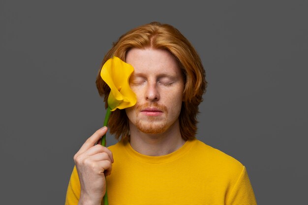 Handsome and sensitive man with flower