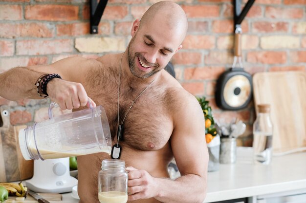 Handsome, shirtless man at kitchen