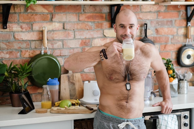 Handsome, shirtless man at kitchen