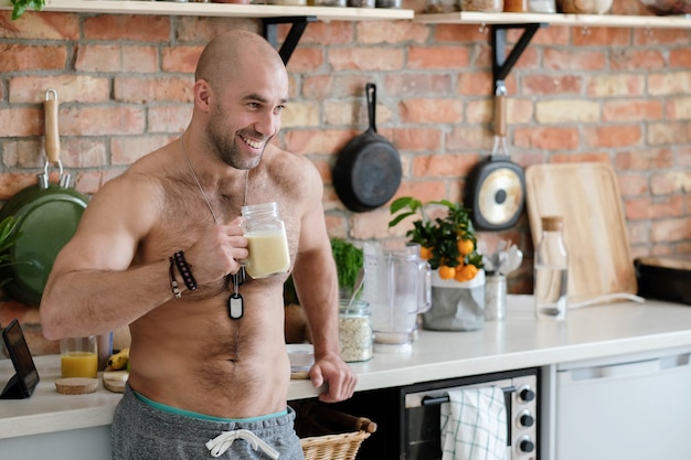 Handsome, shirtless man at kitchen