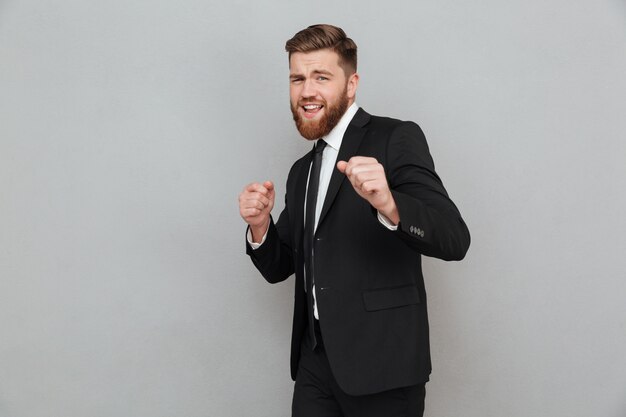 Handsome smiling businessman in suit posing