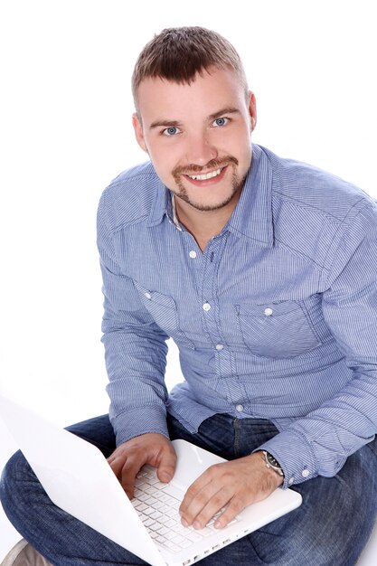 Handsome smiling guy with laptop