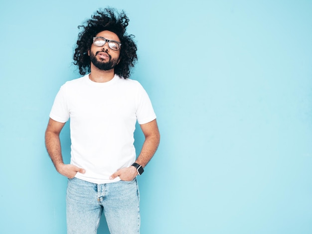 Handsome smiling hipster man posing in studio