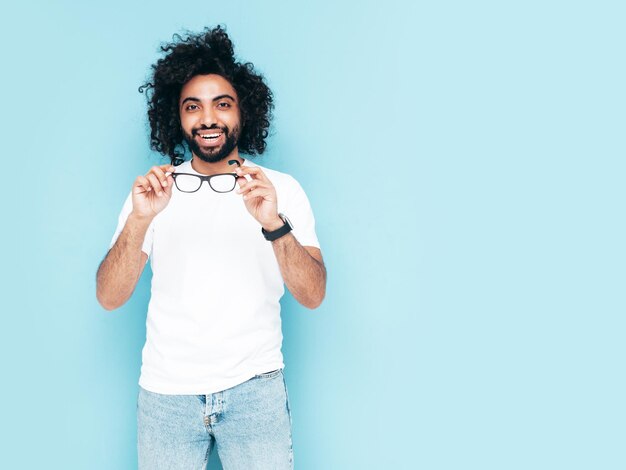 Handsome smiling hipster man posing in studio