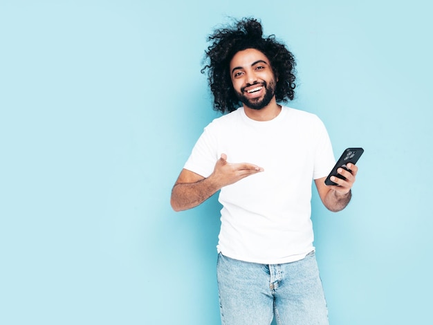 Handsome smiling hipster man posing in studio