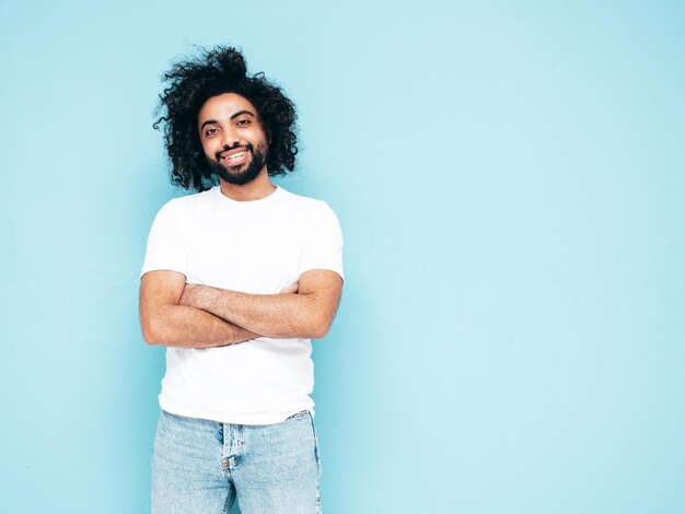 Handsome smiling hipster man posing in studio