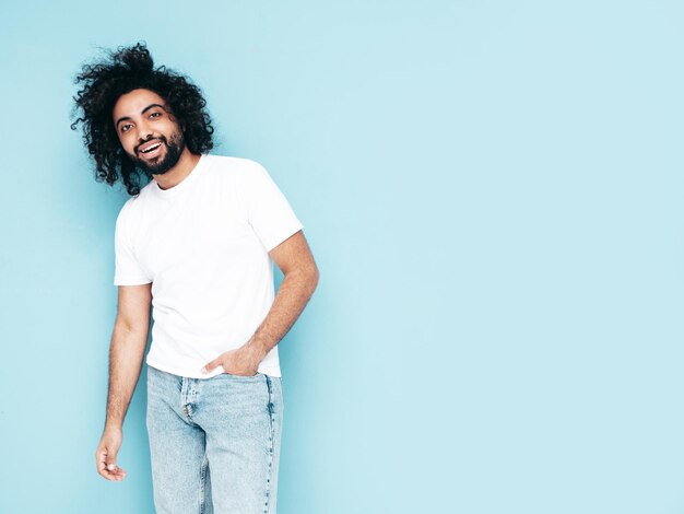 Handsome smiling hipster man posing in studio