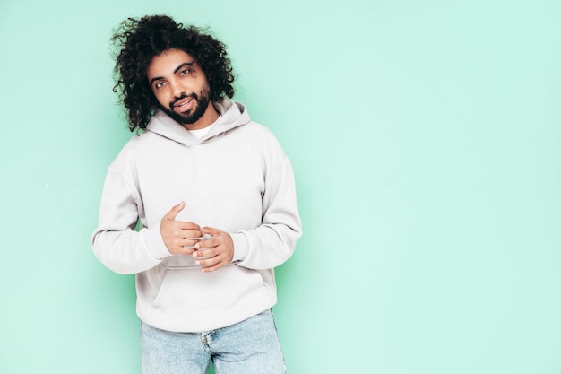 Handsome smiling hipster man posing in studio