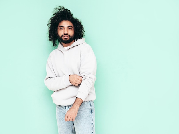 Handsome smiling hipster man posing in studio