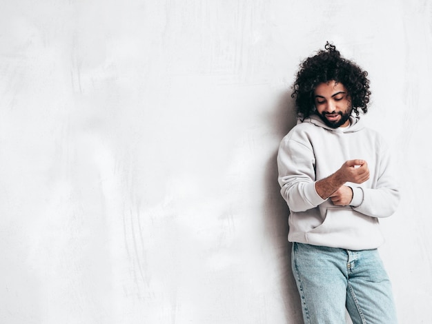 Handsome smiling hipster man posing in studio