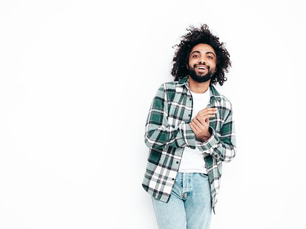 Handsome smiling hipster man posing in studio