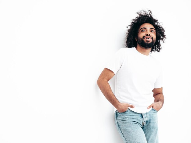 Handsome smiling hipster man posing in studio